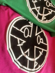 Crass Smileys , Screen Printed, White is raised puff ink